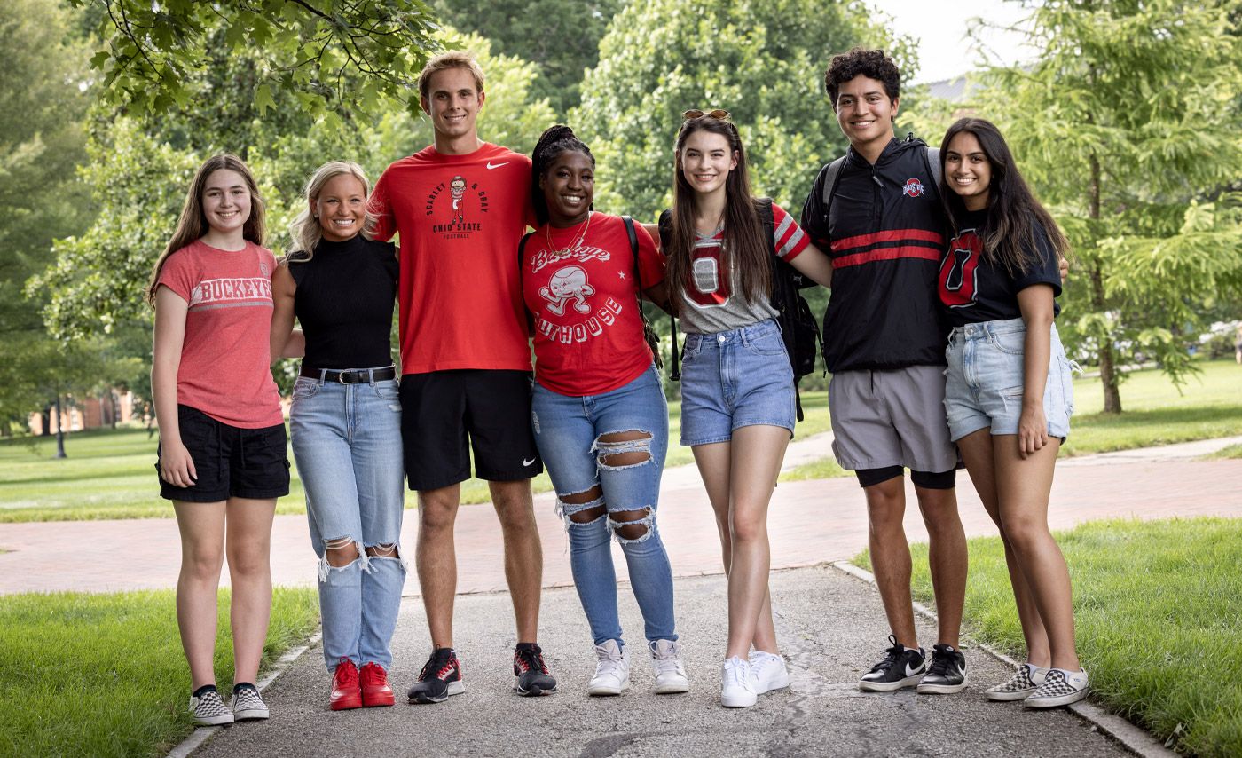 A group of Ohio State students stand together on the Oval.