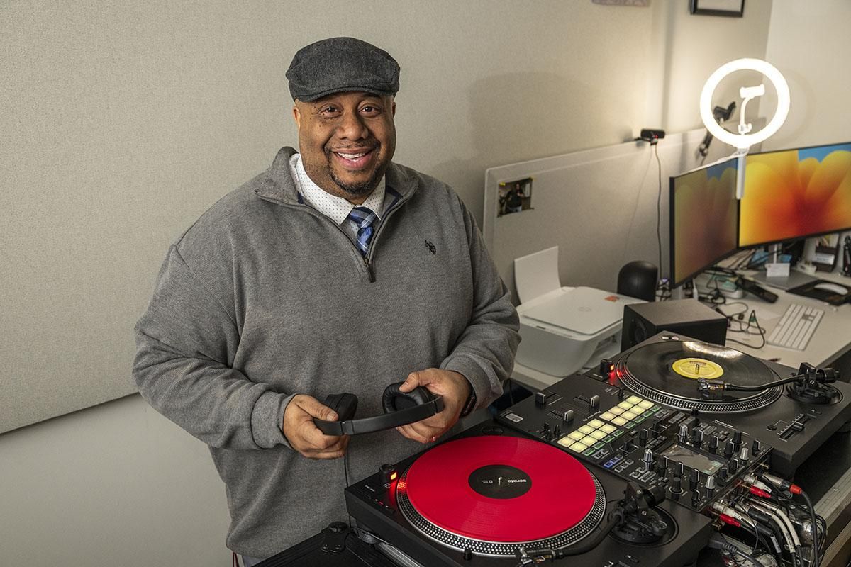 Headshot of Jason ‘J Rawls’ Rawls standing in front of a DJ equipment