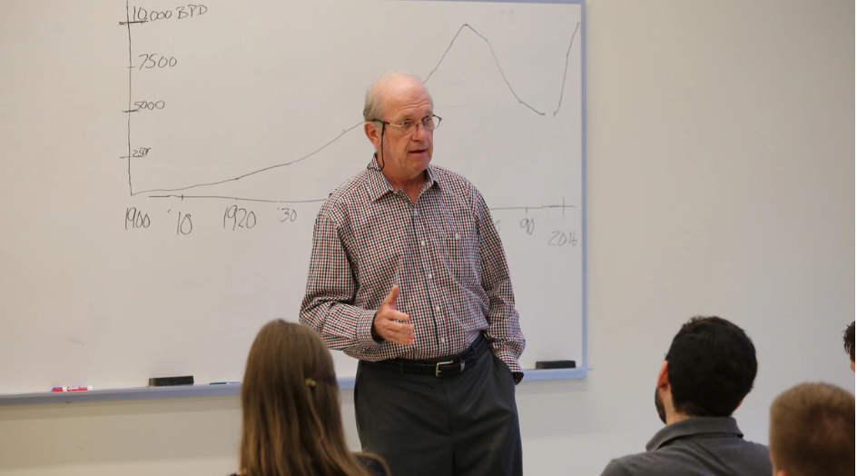 Bill Lowrie standing at the front of a classroom.