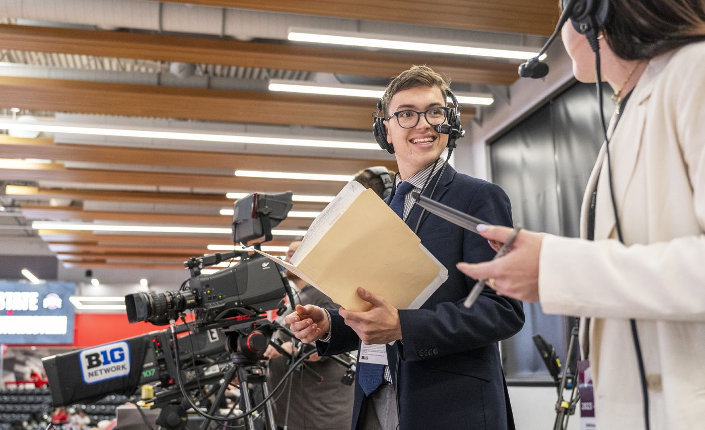 Ohio State student broadcaster Tyler Danburg talks in the broadcast booth at an Ohio State football game