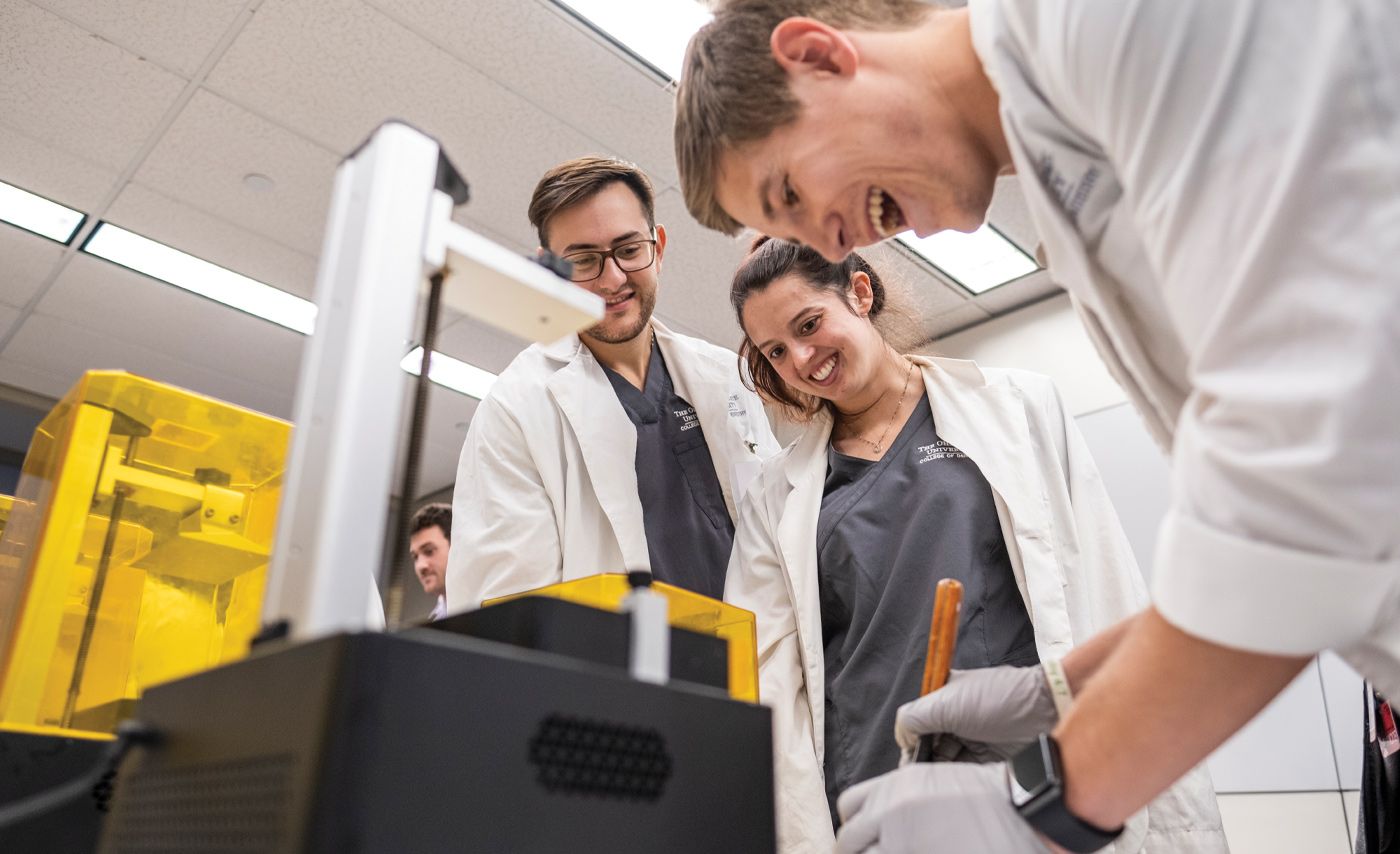 Dentistry students use a 3D printer as part of an exercise.