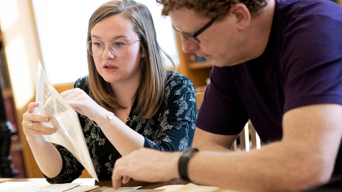 Ohio State student Rose McCandless and Thompson Library special collections curator Eric Johnson examine a medieval manuscript.