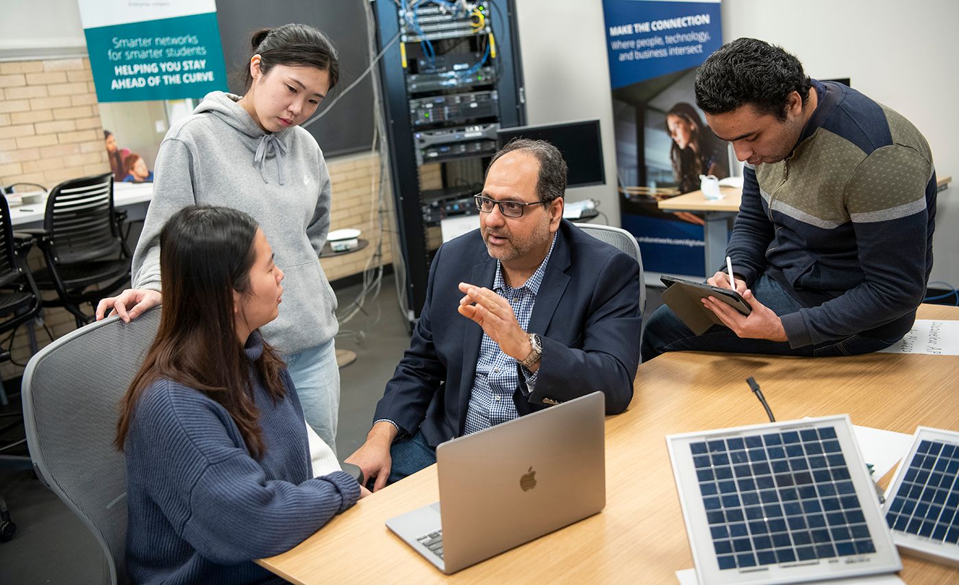 Ohio State AI researcher Ness Shroff talks with grad students.