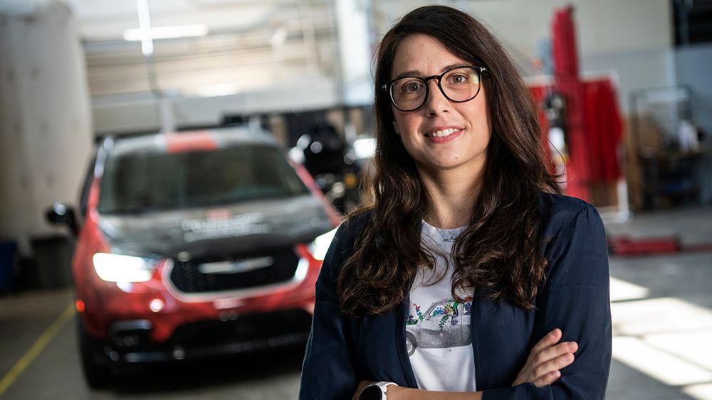 Automotive researcher Stephanie Stockar stands in front of a hybrid vehicle.