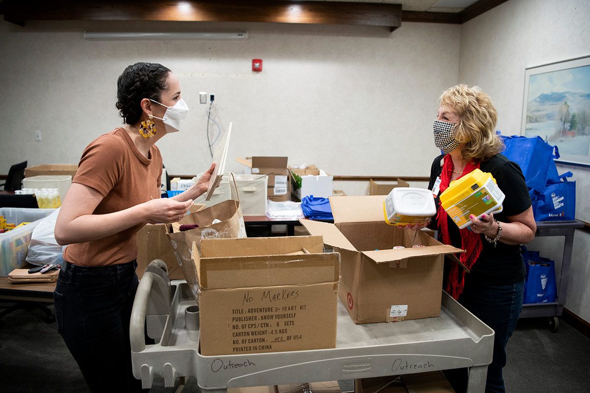 Twinkle Schottke (right) and Michelle Tiburzio assemble bags of food for Moms2B participants during the coronavirus (COVID-19) outbreak.