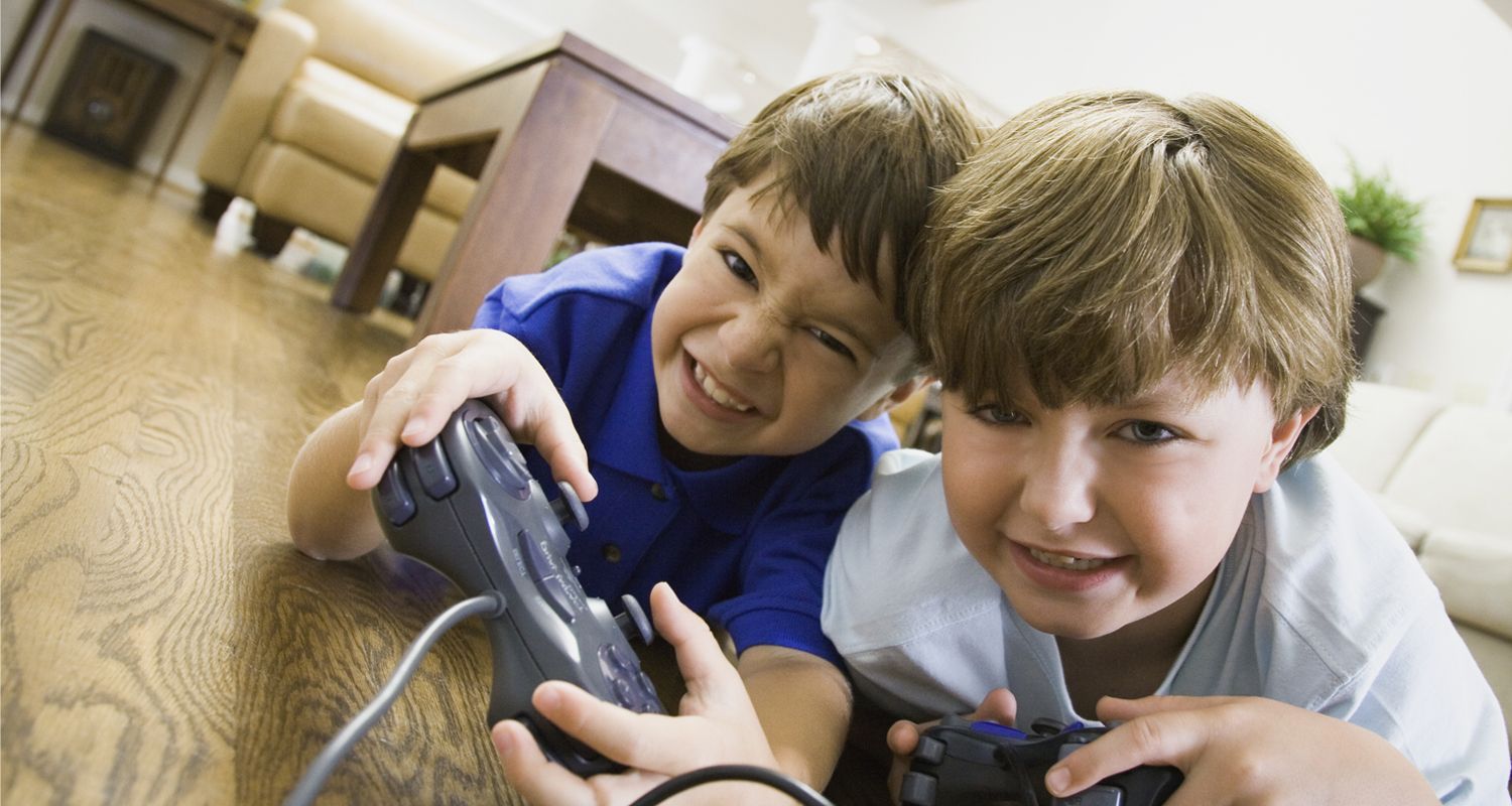 Two young boys aggressively playing video games. © 2019 The Ohio State University