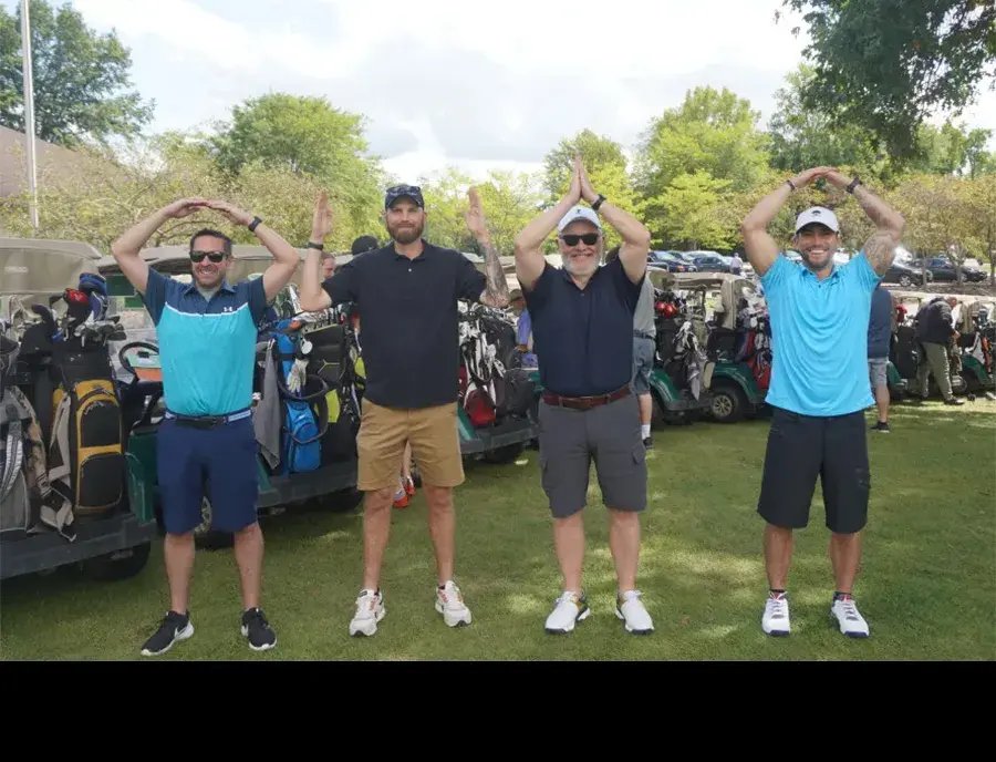 four golfers pose for o-h-i-o