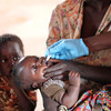 A child receives a polio vaccine from a Child Legacy International health extension worker. (Photo by Ben Belfort)